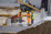 Three engineers in hard hats are discussing on a construction site